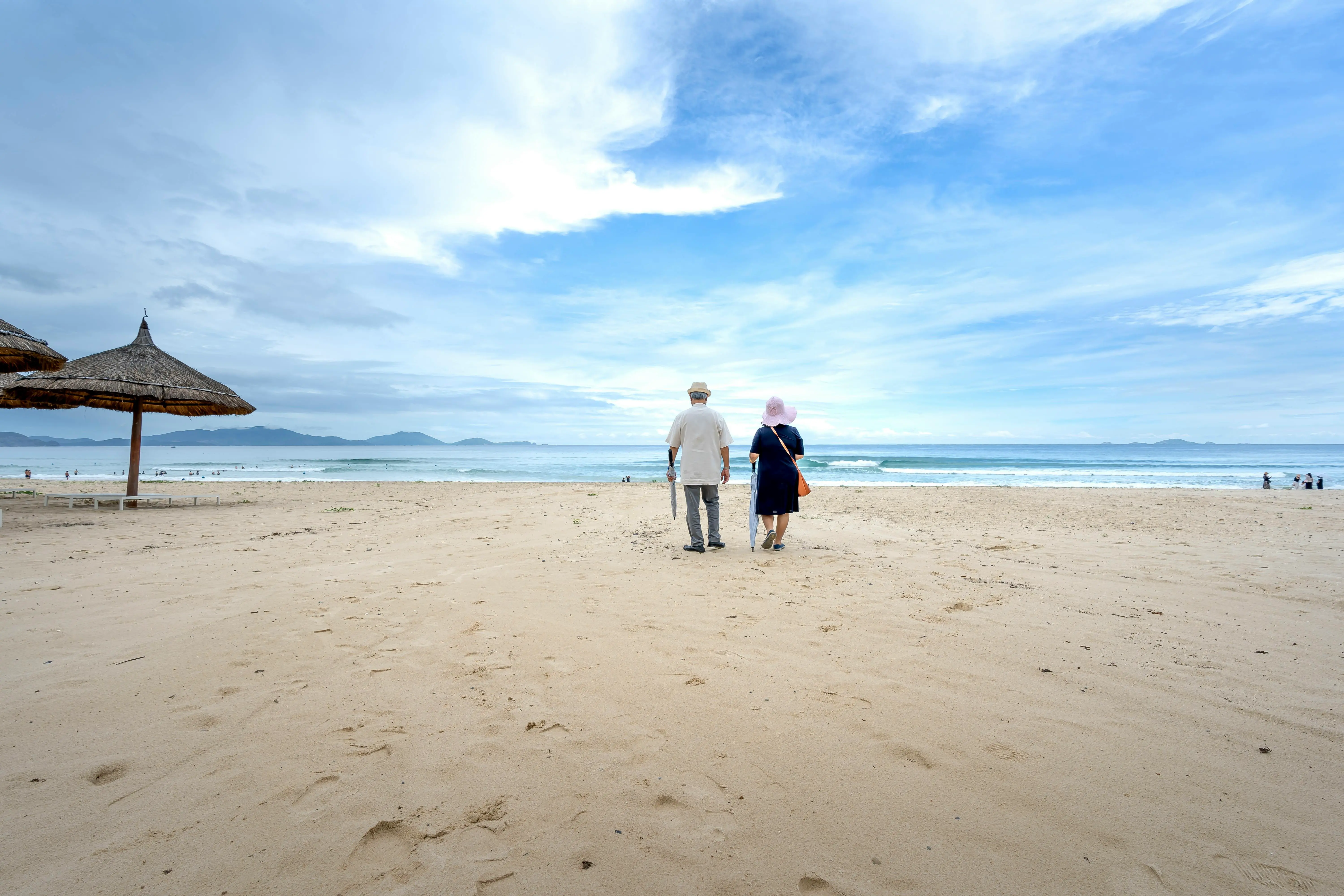 Retired expat couple enjoying life in Thailand by a temple
